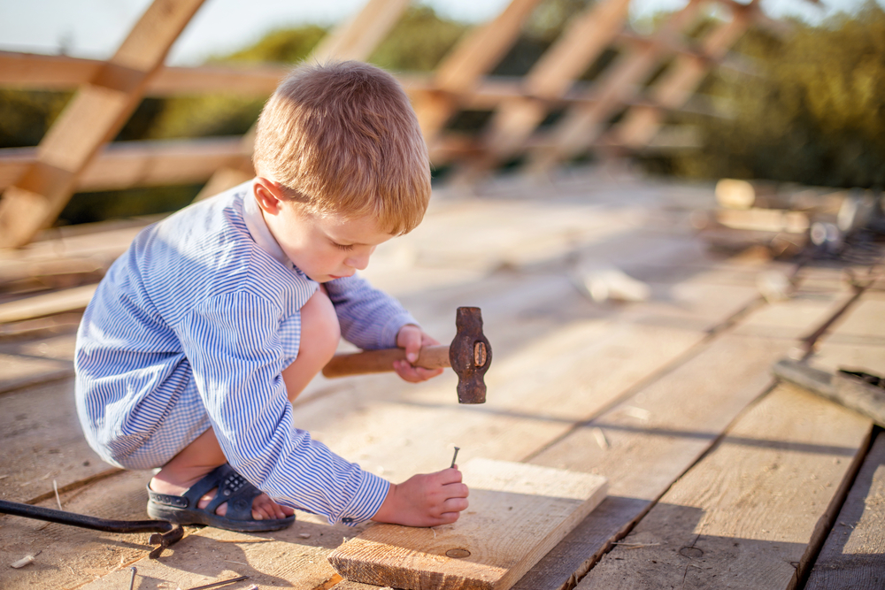 Carpenter using a hammer with AI construction planning tools.