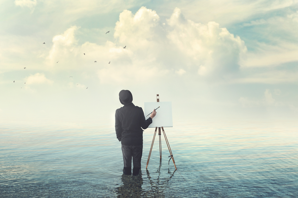 Painter using traditional brushes and AI-generated artwork for reference.