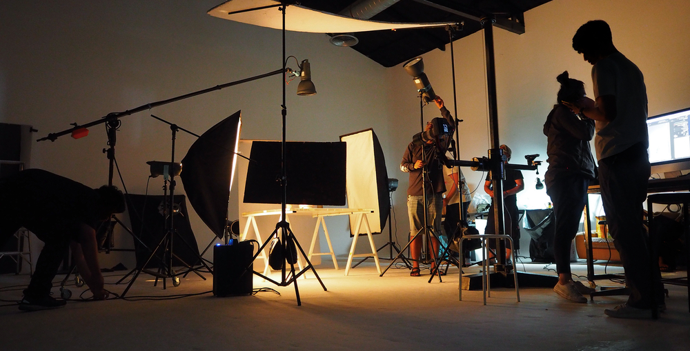 Photographer capturing a scene with AI photo editing in progress.